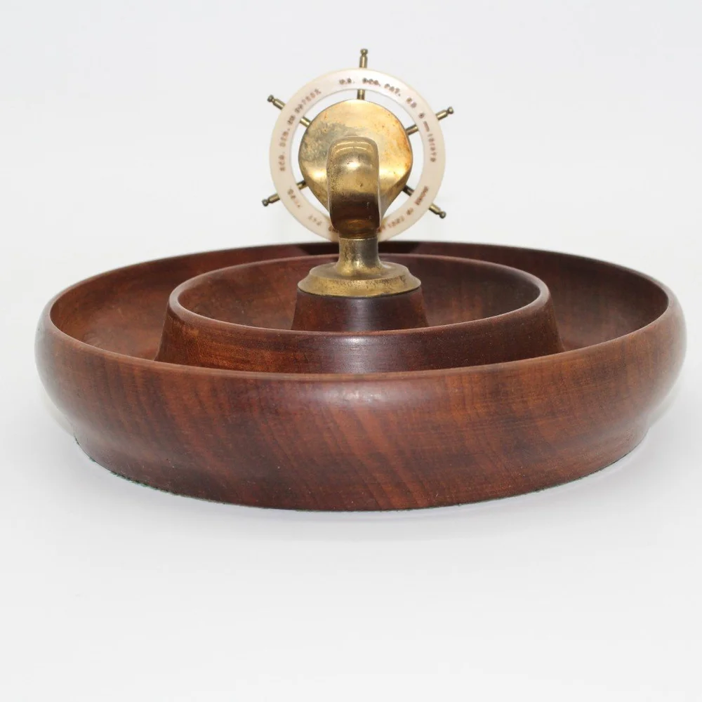 Vintage bakelite ship's wheel nutcracker set on teak bowl -